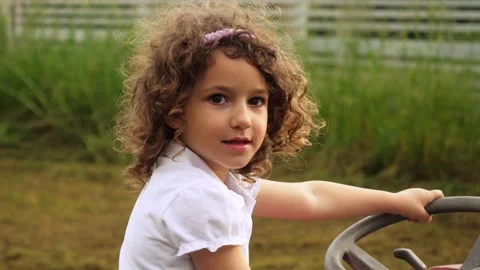Child on father’s tractor smiling during summer day in the fields Stock Footage 307837814
