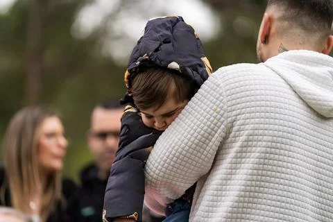 Child feeling secure while being held by parent Stock Photos