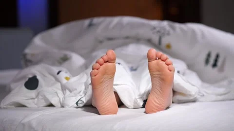 Child feet covered by blanket while sleeping in bed Stock Footage 301717828