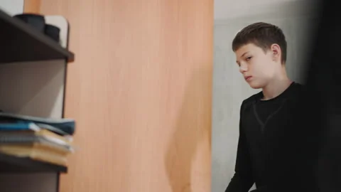 Child finds quiet learning space. Teenage grandson explores peaceful study Stock Footage 337822890
