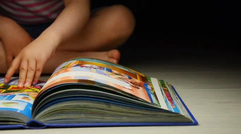 Child flipping book Video stock 38745223