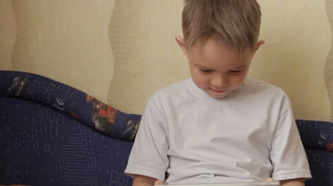 Child focused on screen tablet. Stock Footage 61445603