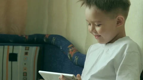 Child focused on screen tablet. Stock Footage 61446056