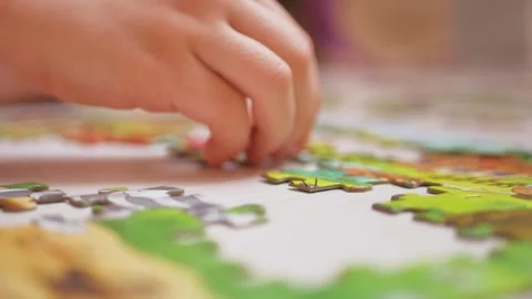 Child Focused on Solving a Puzzle on the Floor Stock Footage 302228477