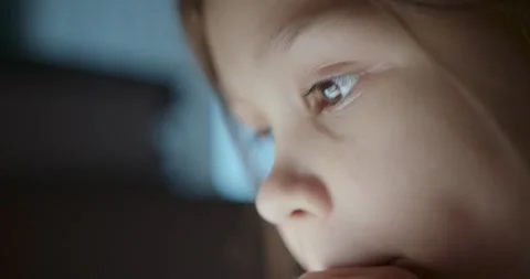 Child focuses intently on engaging screen activities, blending digital creativit 動画素材 288871473