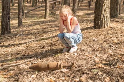 Child found an unexploded rusty projectile Stock Photos