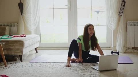 Child in front of a laptop doing gymnastics Video stock 168886853