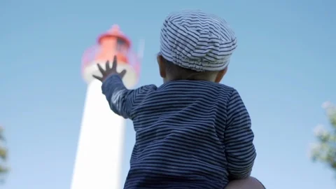 Child in front of a lighthouse Stock Footage 95937804