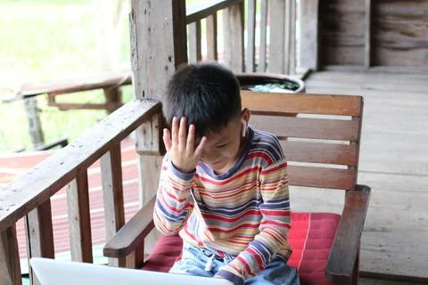 Child with Frustration while Using Laptop in Porch Setting Stock Photos