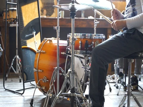 The child fulfills the basic techniques of playing the drum kit with metronome Stock Footage 127803802
