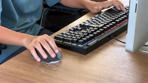 Child gaming hands using mouse and keyboard at desktop computer, static shot Stock Footage 331104716