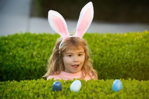 Child gathering eggs, easter egg hunt concept. Children celebrating easter Stock Photos