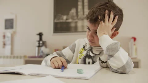 Child gets angry while doing school homework at home because of the lockdown Stock Footage 131723041