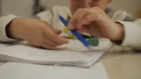 Child gets angry while doing school homework at home because of the lockdown Stock Footage 131723599