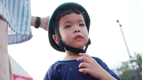 Child getting ready to ride a bicycle in a park on a sunny day Video stock 300013707
