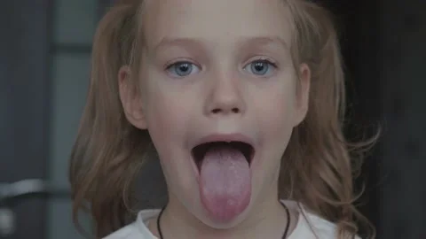 Child girl opens her mouth wide, tongue ... | Stock Video