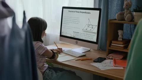 Child girl studying math on computer at home Stock Photos