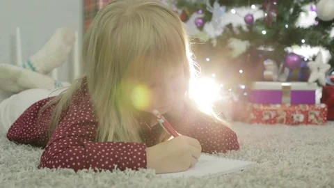 Child girl is thinking what to write Santa. Stock Footage 69836757