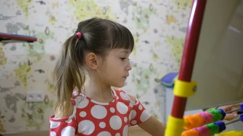 Child girl using abacus to learn numbers and account at home Stock Footage 130884838