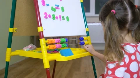 Child girl using abacus to learn numbers and account at home Stock-Footage 132776122