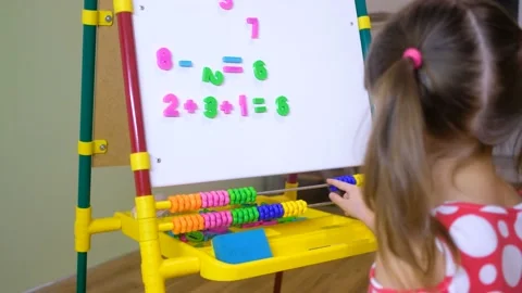 Child girl using abacus to learn numbers and account at home Stock Footage 135711277