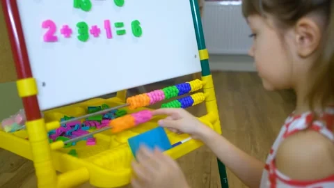 Child girl using abacus to learn numbers and account at home Stock Footage 148079121