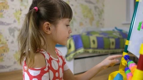 Child girl using abacus to learn numbers and account at home Stock Footage 163255576