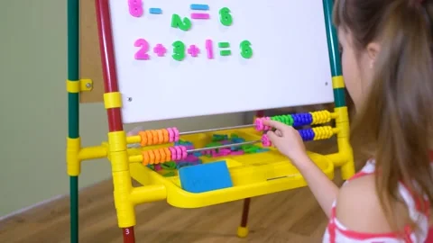Child girl using abacus to learn numbers and account at home Stock Footage 169026532