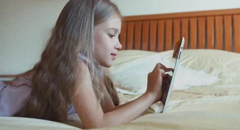 Child girl using tablet pc and looking at camera Stock Footage 55883003