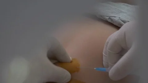 The child is given an injection in the stomach Video stock 121985515