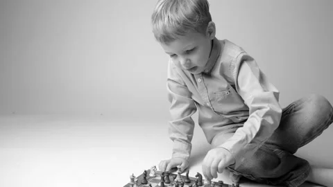 Child with glasses playing chess Stock Footage 150208058