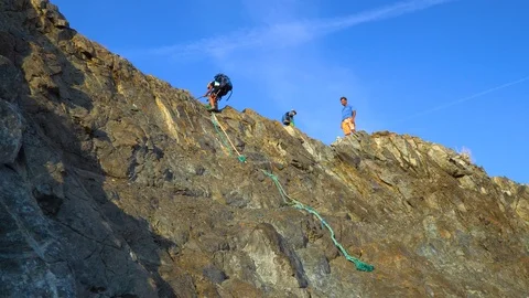 Child goes down the cliff Stock Footage 120847274