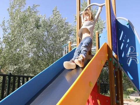 Child goes down on slide Stock Footage 76779958