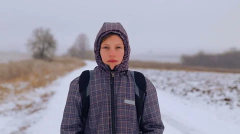 The child goes on a winter road through the fields. Stock Footage 46504907