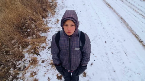 The child goes on a winter road through the fields(top view) . Stock Footage 46526893