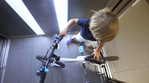 Child going out with bicycle leaving elevator kid leaves elevator 스톡 동영상 183017429