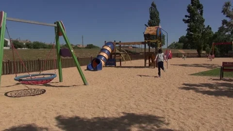 Child going to the rides in a park from Polinya Stock Footage 318963616