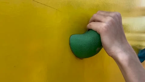 The child grabs the hold of the climbing wall. Stock Footage 158928037