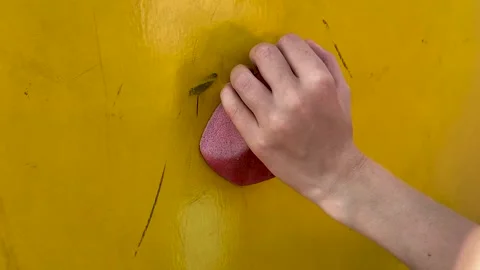 The child grabs the hold of the climbing wall Stock Footage 160705524