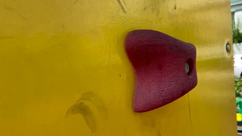 The child grabs the hold of the climbing wall. Construction on the playground Stock Footage 162018353