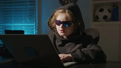 Child hacker practicing safe hacking skills. Child hacker exploring data privacy Stock Footage 342092533
