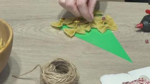 Child Hand Adding Beads To Pasta Christmas Tree Craft Handmade Holiday School Stock Footage 341985831