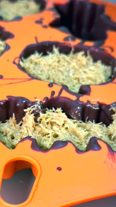Child hand adds cracker into chocolate mold. Cracker joins filling. Cookie Stock Footage 343478150