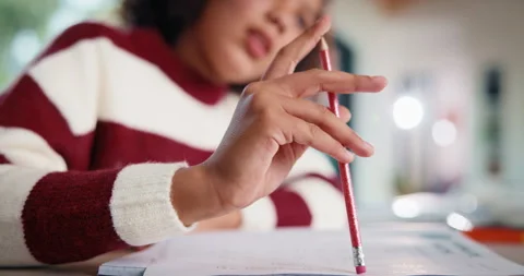 Child, hand and thinking with homework, pencil and writing answer with education Stockbeeldmateriaal 335525457