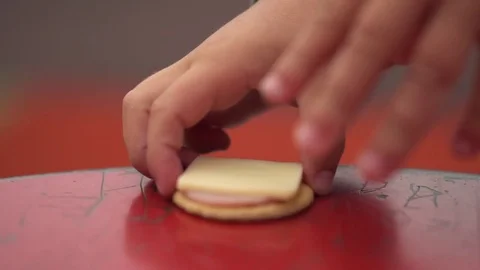 Child hand grabbing crackers witch cheese  Stock Footage 79927150