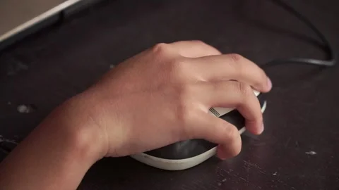 Child hand navigating computer mouse. Home learning, digital skills, and Stock Footage 327613995