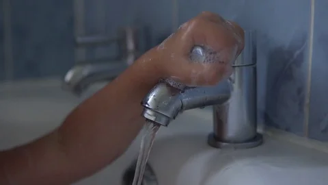 Child hand opening tap of water Stock Footage 79961696
