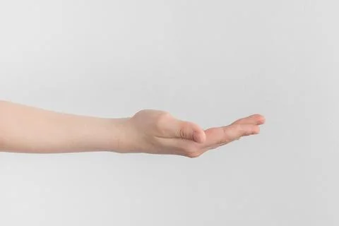 Child hand palm up. side view Isolated on a white anf gray background close-u Stock Photos