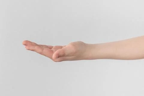 Child hand palm up. side view Isolated on a white anf gray background close-u Stock Photos
