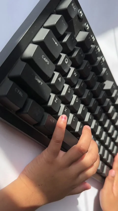 Child hand pressing keyboard keys Stock Footage 328486659